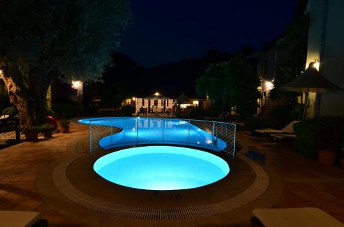 a large blue swimming pool at night at Olive Garden Apart Hotel in Göcek