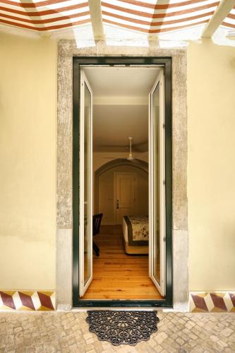 a room with a door open to a bedroom at Casas de São Bento in Lisbon