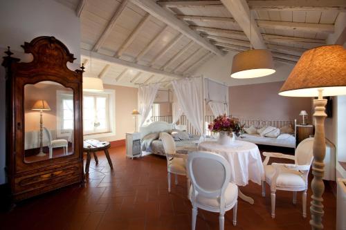 a living room with a table and a bedroom at Agriturismo Cascina Caremma in Besate