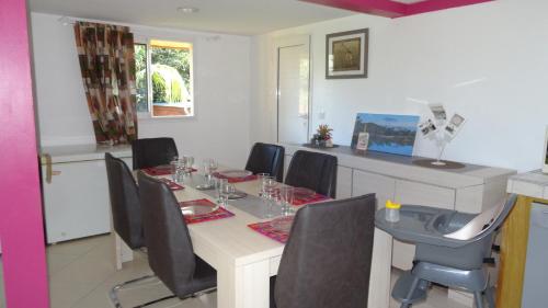 a dining room with a long table and chairs at Boule de bleu in Le Tampon