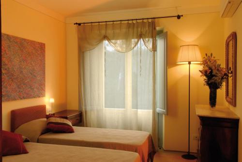 a hotel room with two beds and a window at Residenza Ca De Frati in Arezzo