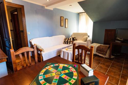 a living room with a couch and a table at Hotel Peña Pandos in Felechosa