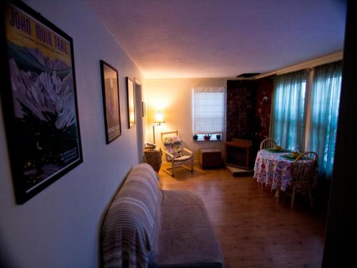 a living room with a couch and a table at Cozy Muir Cottage - In Town - Pet Friendly in Lone Pine