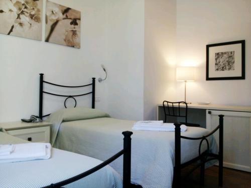 מיטה או מיטות בחדר ב-Luconi Affittacamere