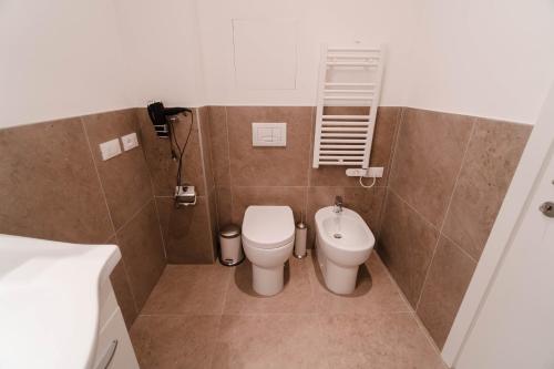 a bathroom with a toilet and a sink at The Arc Residence in Astana