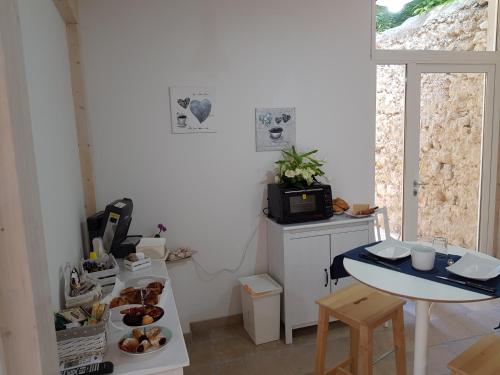 a small kitchen with a table and a small table and a table and a table at Il Daviduccio Suite in Siracusa