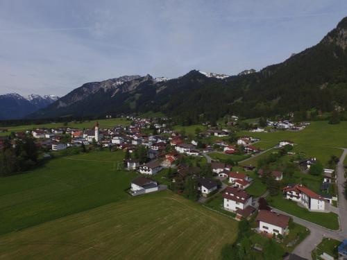 an aerial view of a small village in a green field at Haus Müller in Reutte