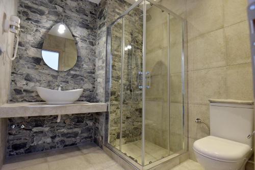 a bathroom with a shower and a toilet and a sink at Aqua Marine in Neos Marmaras