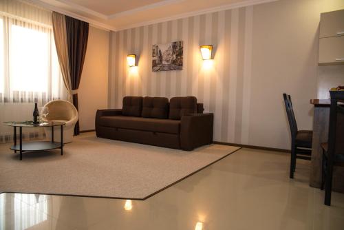a living room with a couch and a table at Adele in Mizhhirʼʼya