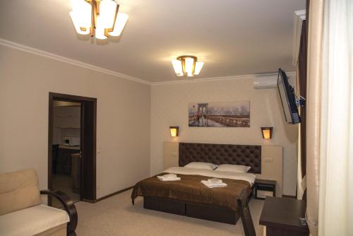 a bedroom with a bed and a couch and a chair at Adele in Mizhhirʼʼya
