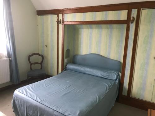 a bedroom with a bed with a wooden frame at Mazmoura in Reignac-sur-Indre