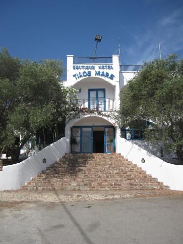 a building with stairs leading up to the door at Boutique Hotel Tilos Mare in Livadia