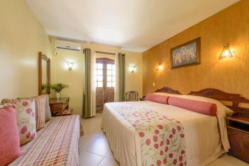 Ein Bett oder Betten in einem Zimmer der Unterkunft Pousada dos Pireneus