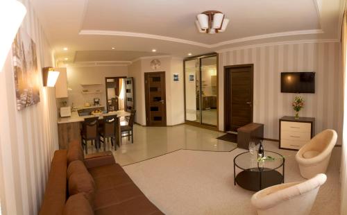 a living room with a couch and a table at Adele in Mizhhirʼʼya