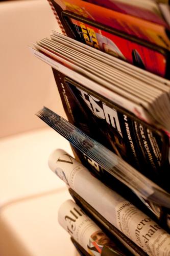 a pile of magazines stacked on top of each other at Hotel Cristall - Frankfurt City in Frankfurt/Main