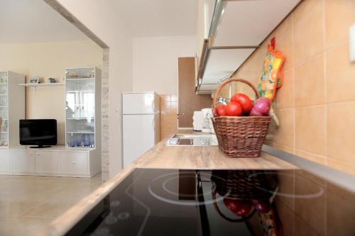 a kitchen with a basket of fruit on a counter at Apartment Carmen in Trogir