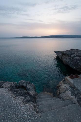 a view of a body of water with rocks at Studios Angeliki in Lassi