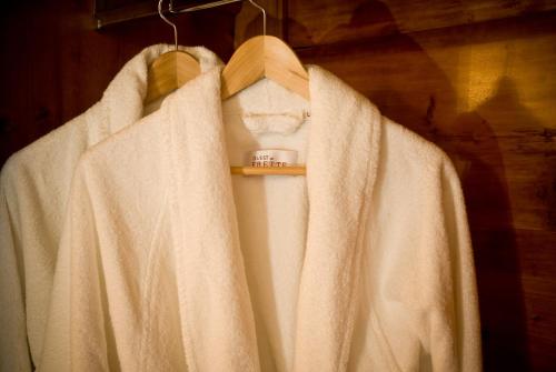 a white robe is hanging on a hanger at Callegherie 21 Boutique B&B in Imola