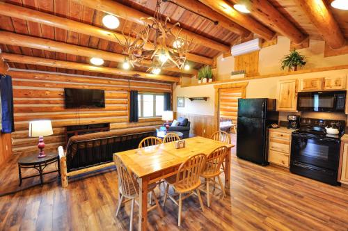 a kitchen and living room with a table and chairs at Paddle Ridge in West Glacier
