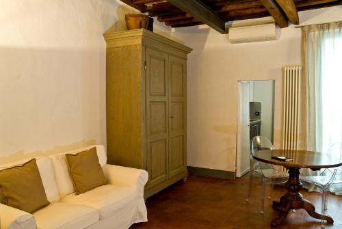 a living room with a couch and a table at Callegherie 21 Boutique B&B in Imola