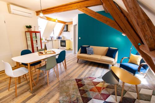 a living room with a table and chairs at La Grange de Madeleine in Eguisheim