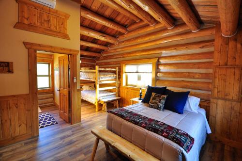 a bedroom with a bed in a log cabin at Glacier Homestead in Coram