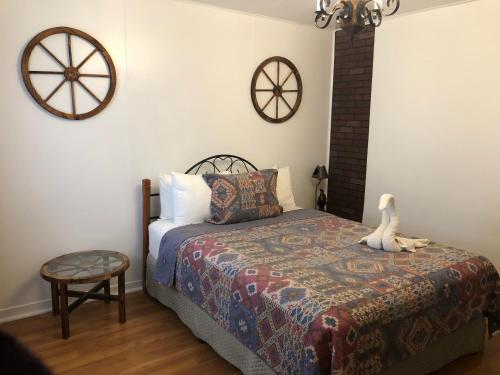 a bedroom with a bed with a stuffed animal on it at The Rex Motel At Niagara Falls in Niagara Falls