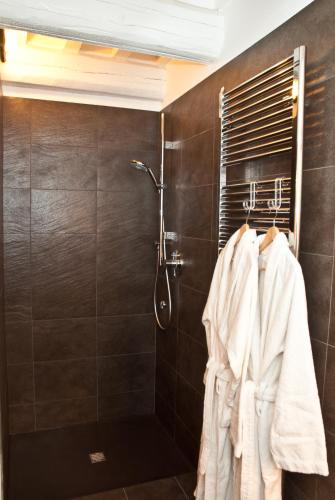 a bathroom with a shower with white towels at Callegherie 21 Boutique B&B in Imola