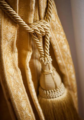 a close up of a curtain with a broomstick at Hotel Villa Cornér Della Regina in Vedelago