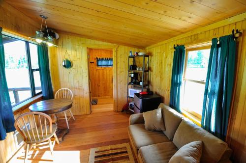 a living room with a couch and a table at Glacier Homestead in Coram