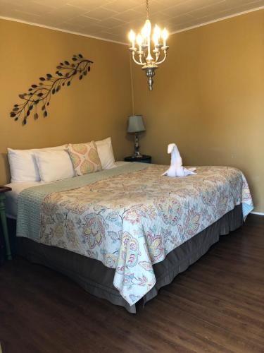 a bedroom with a bed with a teddy bear on it at The Rex Motel At Niagara Falls in Niagara Falls