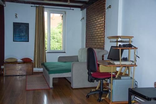 a living room with a couch and a desk with a computer at Mara in Zaječar