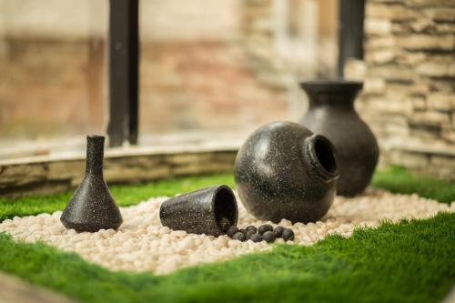 a group of vases sitting on the grass at South Gate Residency in Cochin