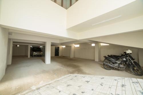 a garage with a motorcycle parked in it at South Gate Residency in Cochin
