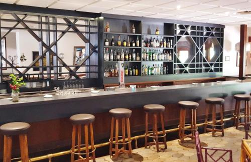 a bar with brown stools in a restaurant at Parador de Ceuta in Ceuta