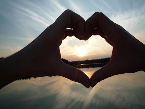 a pair of hands in the shape of a heart over water at Apartmajsko naselje Ribniško Pohorje in Ribnica na Pohorju