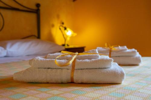 three folded towels sitting on top of a bed at Villa Nigro in Laureana Cilento