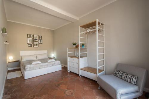 a bedroom with a bed and a chair at Old Town Torino in Turin