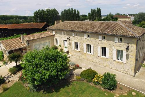 an aerial view of a house with a yard at Domaine Des Deux Rivières in Meilhan-sur-Garonne