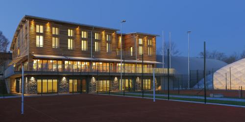 a large wooden building with a lot of windows at Esmarin wellness hotel in Mníšek pod Brdy