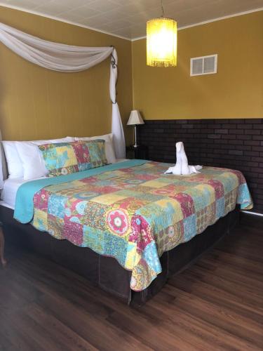 a bedroom with a bed with a stuffed animal on it at The Rex Motel At Niagara Falls in Niagara Falls