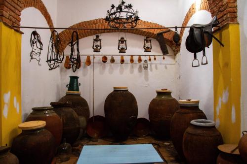 a group of vases are sitting in a room at D. TERESINHA in Vila de Frades