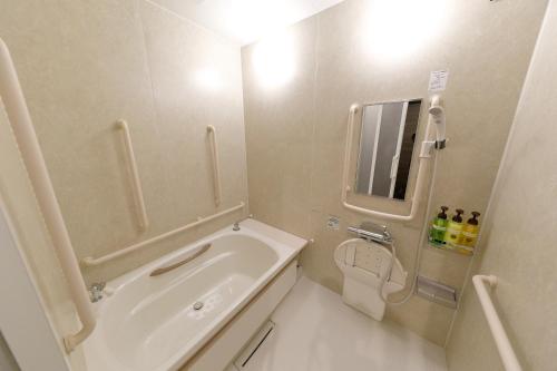 a bathroom with a sink, toilet and bathtub at Act Hotel Roppongi in Tokyo