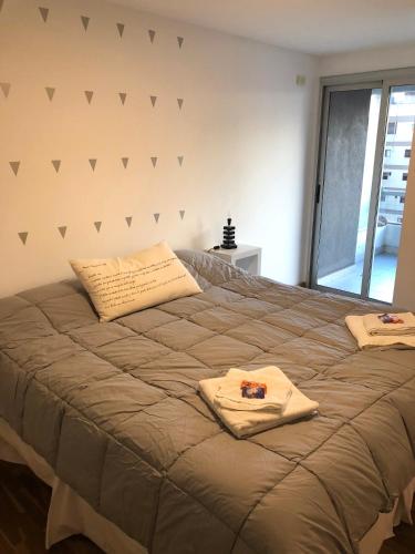 a bedroom with a bed with two pillows on it at Departamentos Mediterraneo in Córdoba