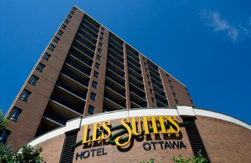 a building with a sign on the front of it at Les Suites Hotel in Ottawa
