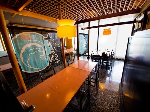 a dining room with a long wooden table and chairs at Naruto Grand Hotel Kaigetsu in Naruto