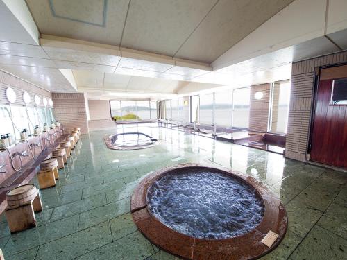 a large swimming pool in the middle of a building at Naruto Grand Hotel Kaigetsu in Naruto