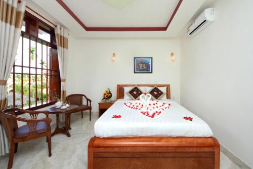 Postel nebo postele na pokoji v ubytování Hoi An Dat Cam Homestay