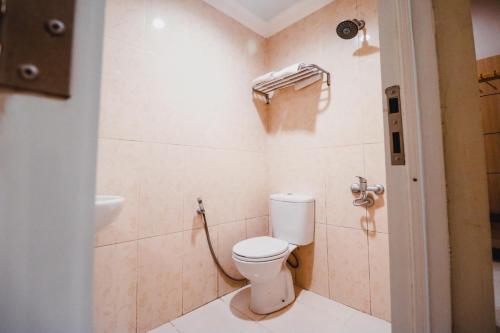 a bathroom with a toilet and a sink at Reddoorz Plus near Makassar Town Square in Makassar