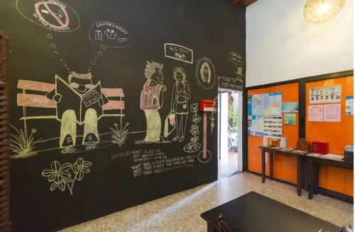 a room with a wall with drawings on it at Cocoa Mews Cafe and Homestay in George Town
